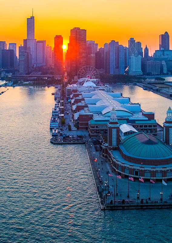 A red sunset behind Chicago's skyline and Navy Pier.,