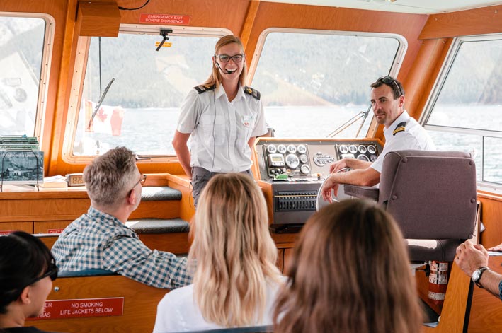 A Boat captain and guide talks to boat guests 