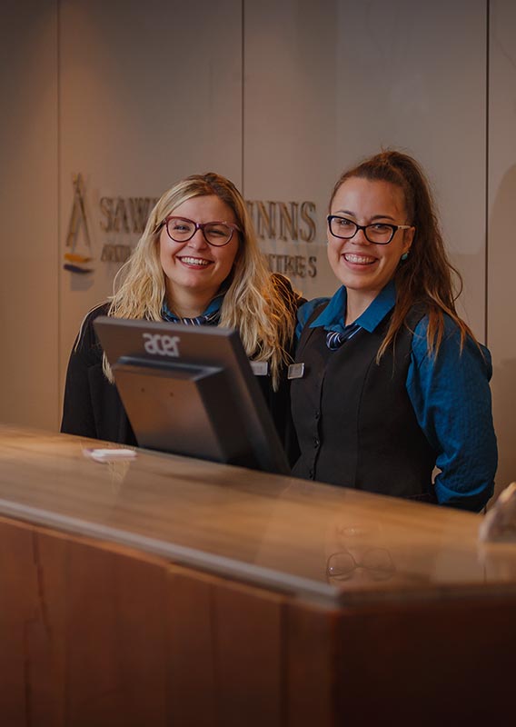 Two workers at a hotel front desk