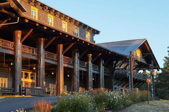 Sunlight shines on the wooden facade of the Glacier Park Lodge